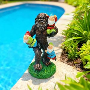 Bigfoot statue carrying garden gnomes