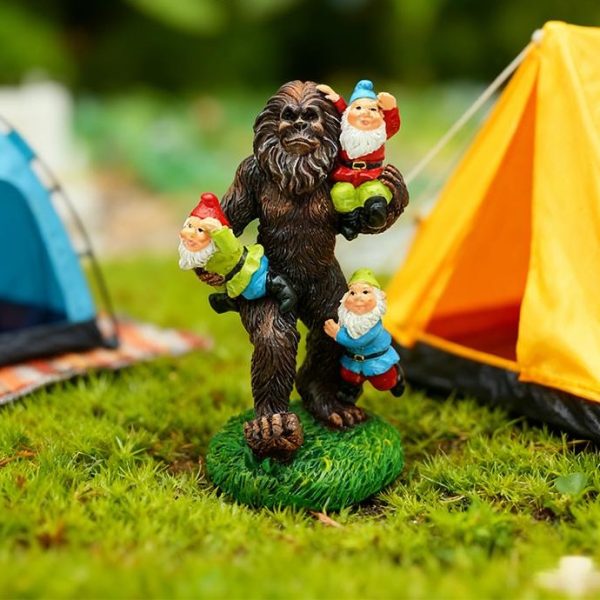 Bigfoot statue carrying garden gnomes