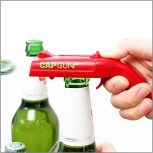 The cap gun bottle opener gripping a bottle cap