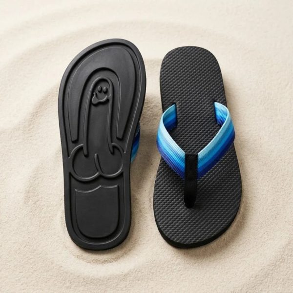 The flip-flops on sand with their surprise print
