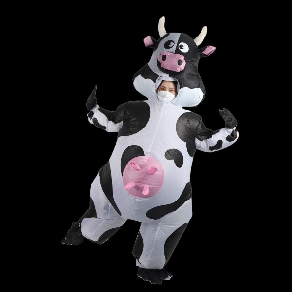Inflatable cow costume worn by an adult