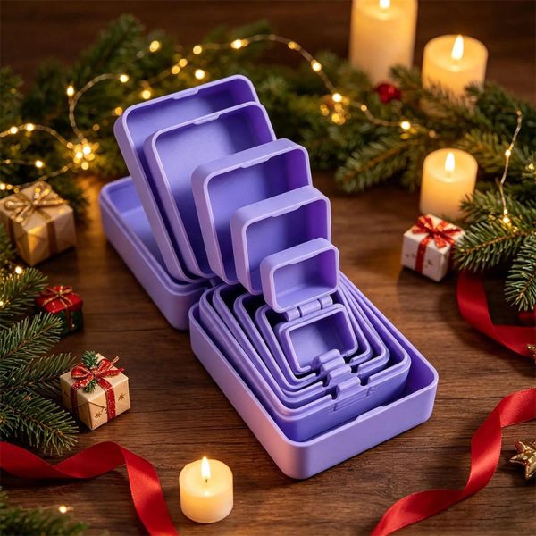 Purple nested prank gift boxes among christmas decorations