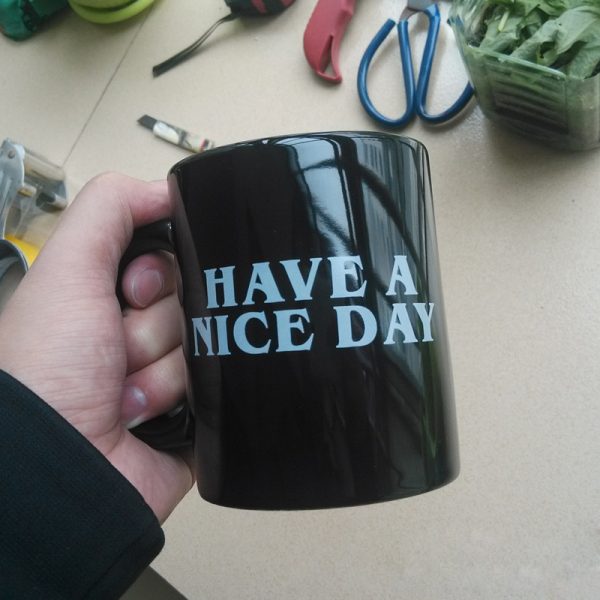 Have a Nice Day mug in hand