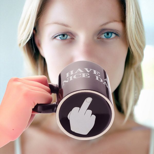 Drinking from the Have a Nice Day mug reveals the finger