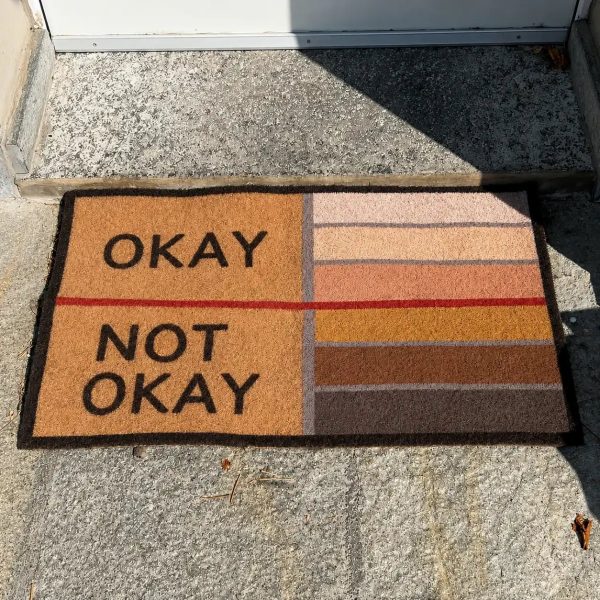 The OKAY NOT OKAY doormat at the front door
