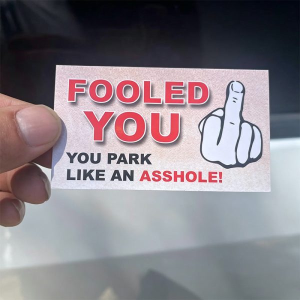 The fooled you parking prank card in hand