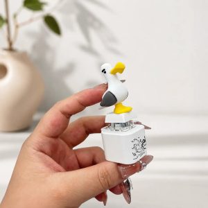 The seagull keychain in a hand