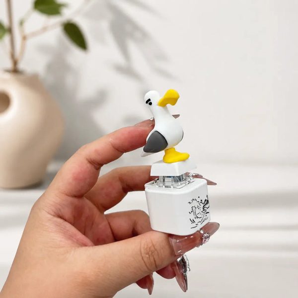 The seagull keychain in a hand