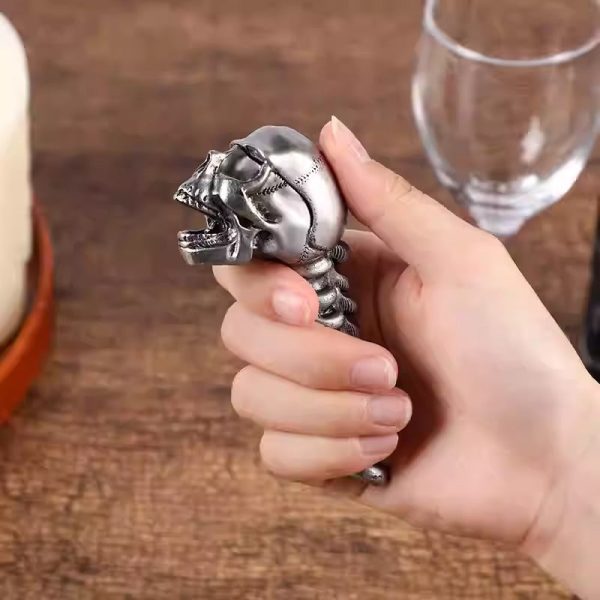 The skull and spine bottle opener in hand