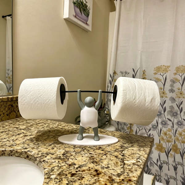 Weightlifter toilet paper holder in the bathroom