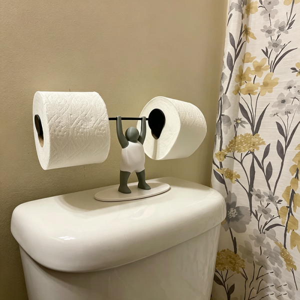 Weightlifter toilet paper holder in the bathroom