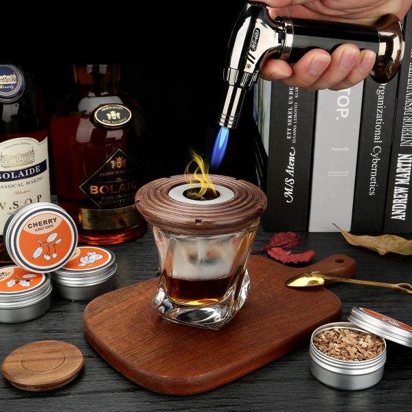 Cocktail smoker kit in use with torch