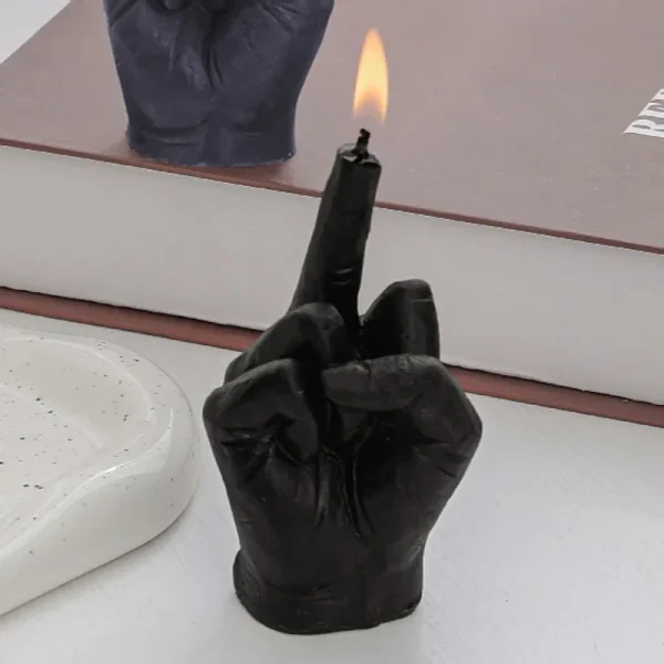 Candle shaped like a hand raising the middle finger