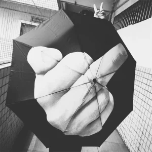Black folding umbrella printed with a middle finger