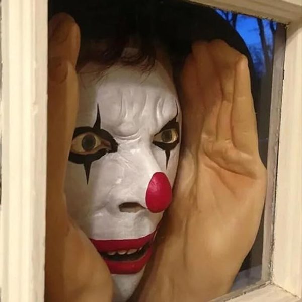 Scary peeper prop of a clown pressing his face to a window