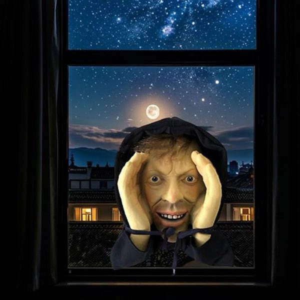 Scary peeper prop of a hooded man pressing his face to a window