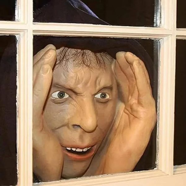 Scary peeper prop of a hooded man pressing his face to a window